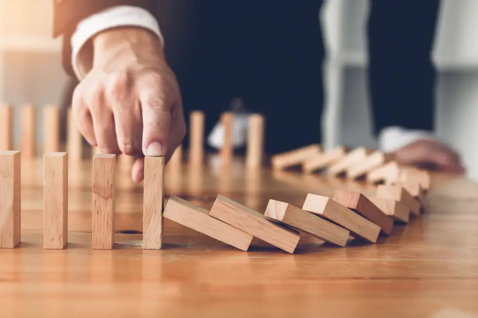 Domino Effect Halted By Businessman Domino Effect Halted By Businessman