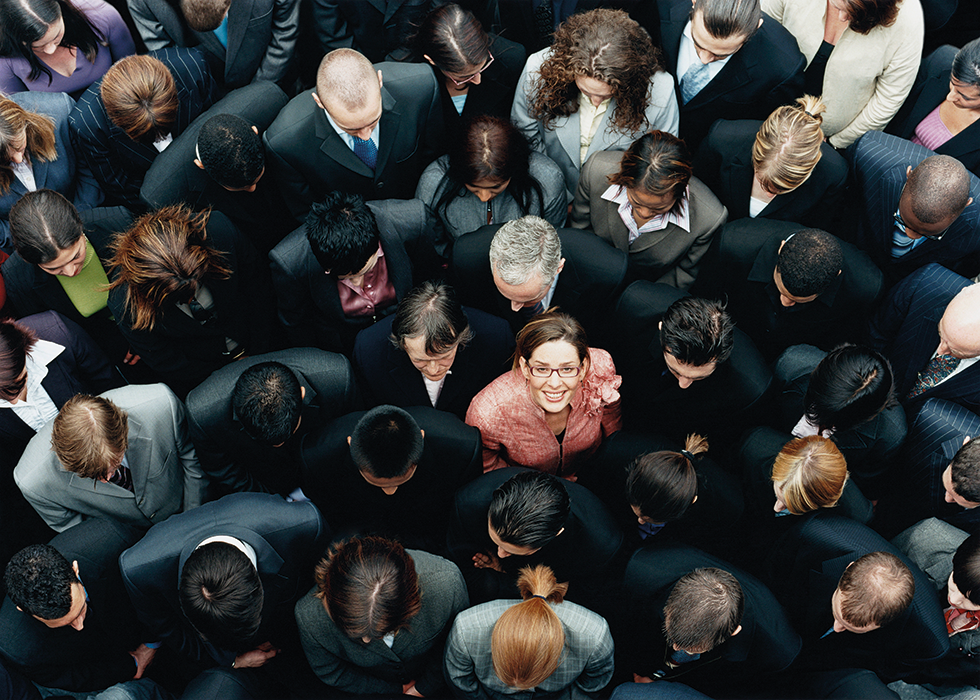 Business Woman Looking Up From Crowd